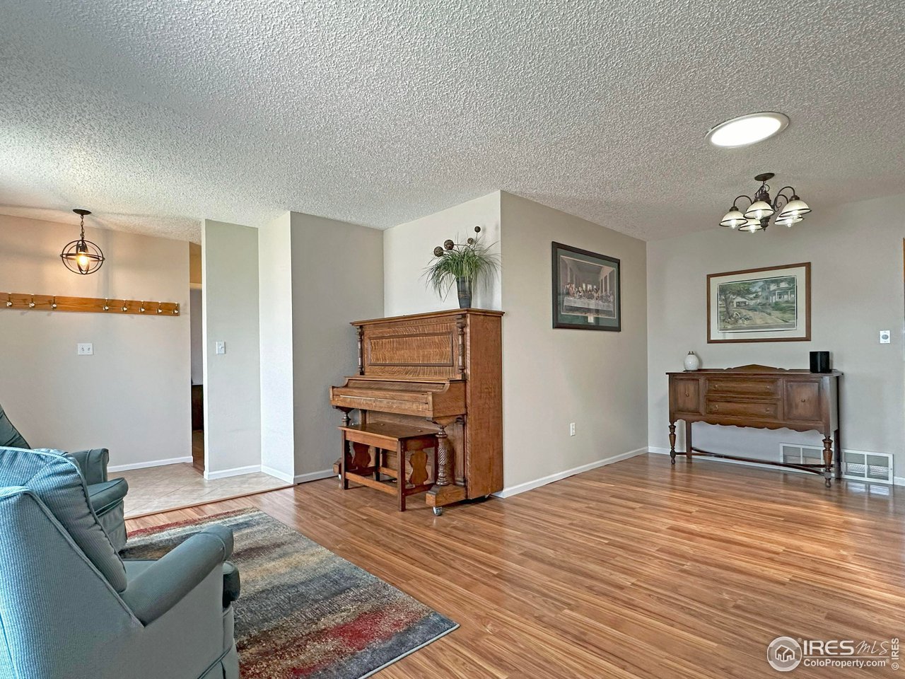 807 Locust Street Windsor, CO 80550 - Photo 4 of 40 a living room with furniture and a wooden floor