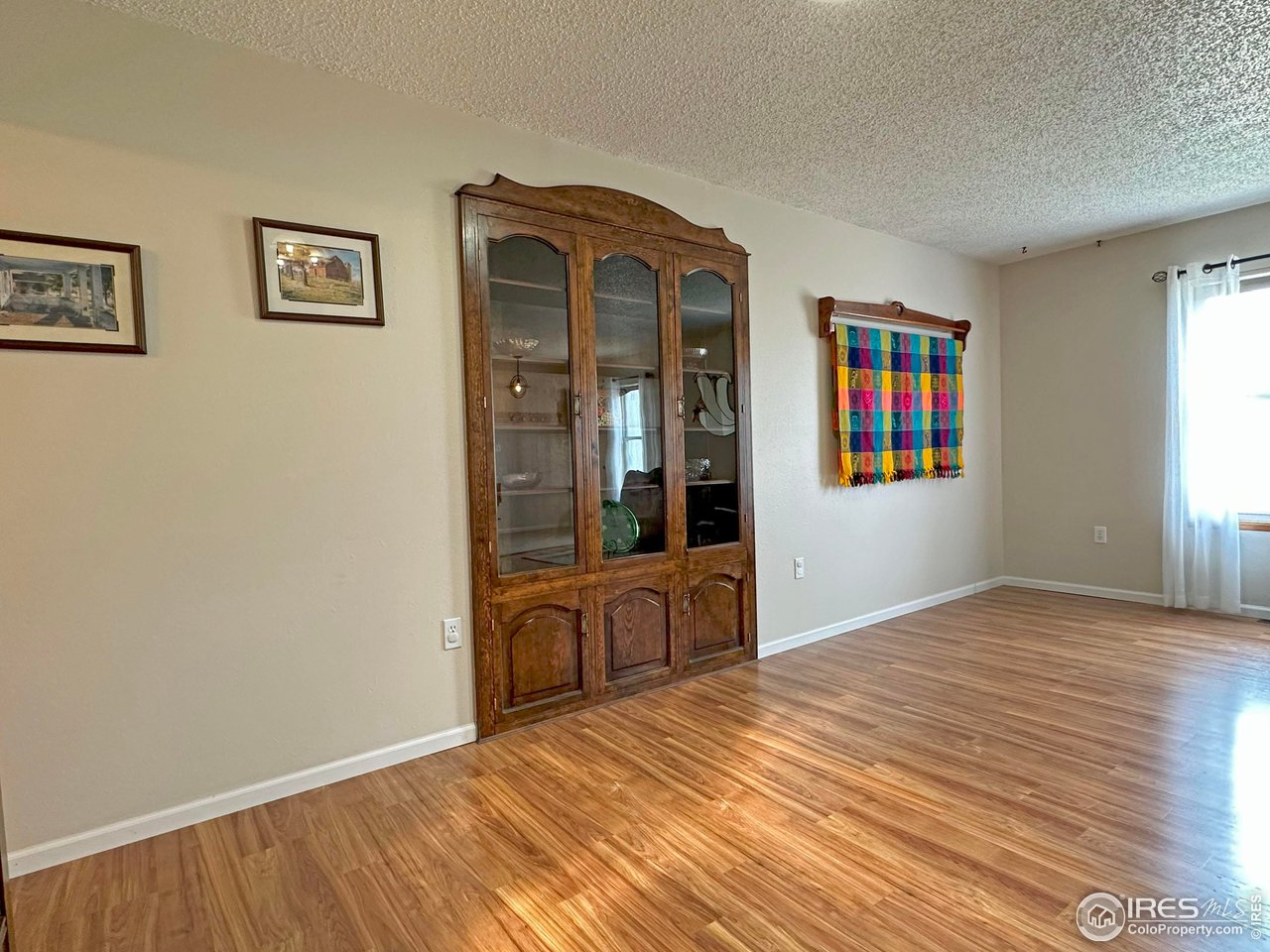 807 Locust Street Windsor, CO 80550 - Photo 5 of 40 a view of an empty room with window and wooden floor
