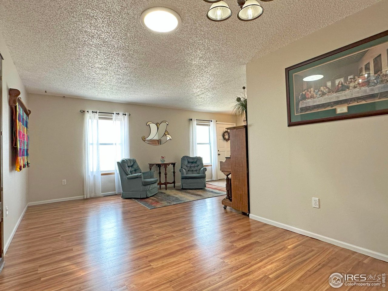 807 Locust Street Windsor, CO 80550 - Photo 6 of 40 a living room with furniture and wooden floor