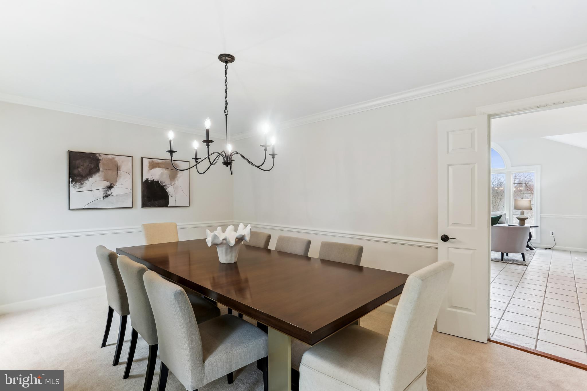9409 Thornedike Drive Laytonsville, MD 20882 - Photo 17 of 86 a view of a dining room with a table and chairs