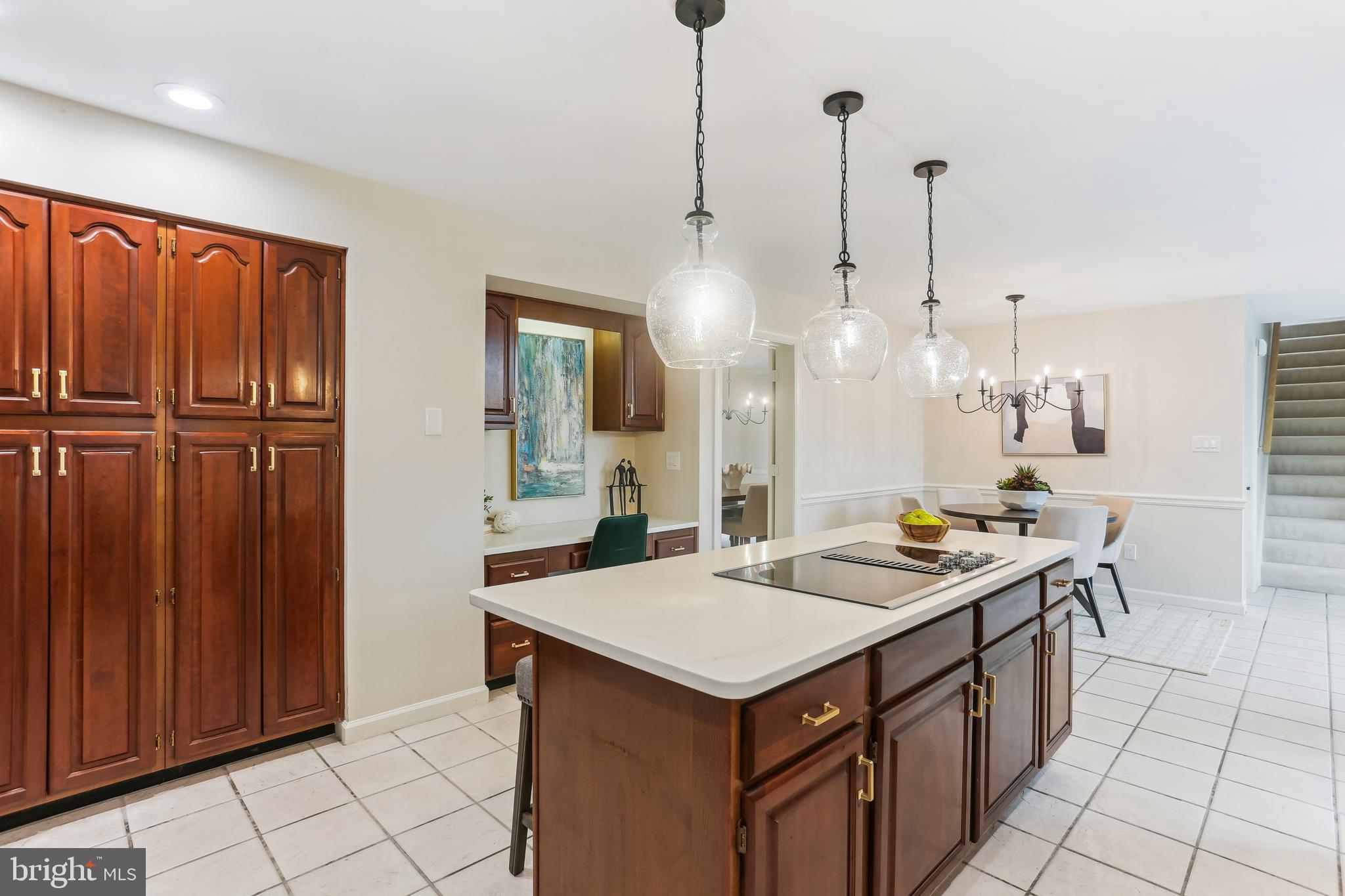 9409 Thornedike Drive Laytonsville, MD 20882 - Photo 19 of 86 a kitchen that has a kitchen island wooden cabinets and stainless steel appliances