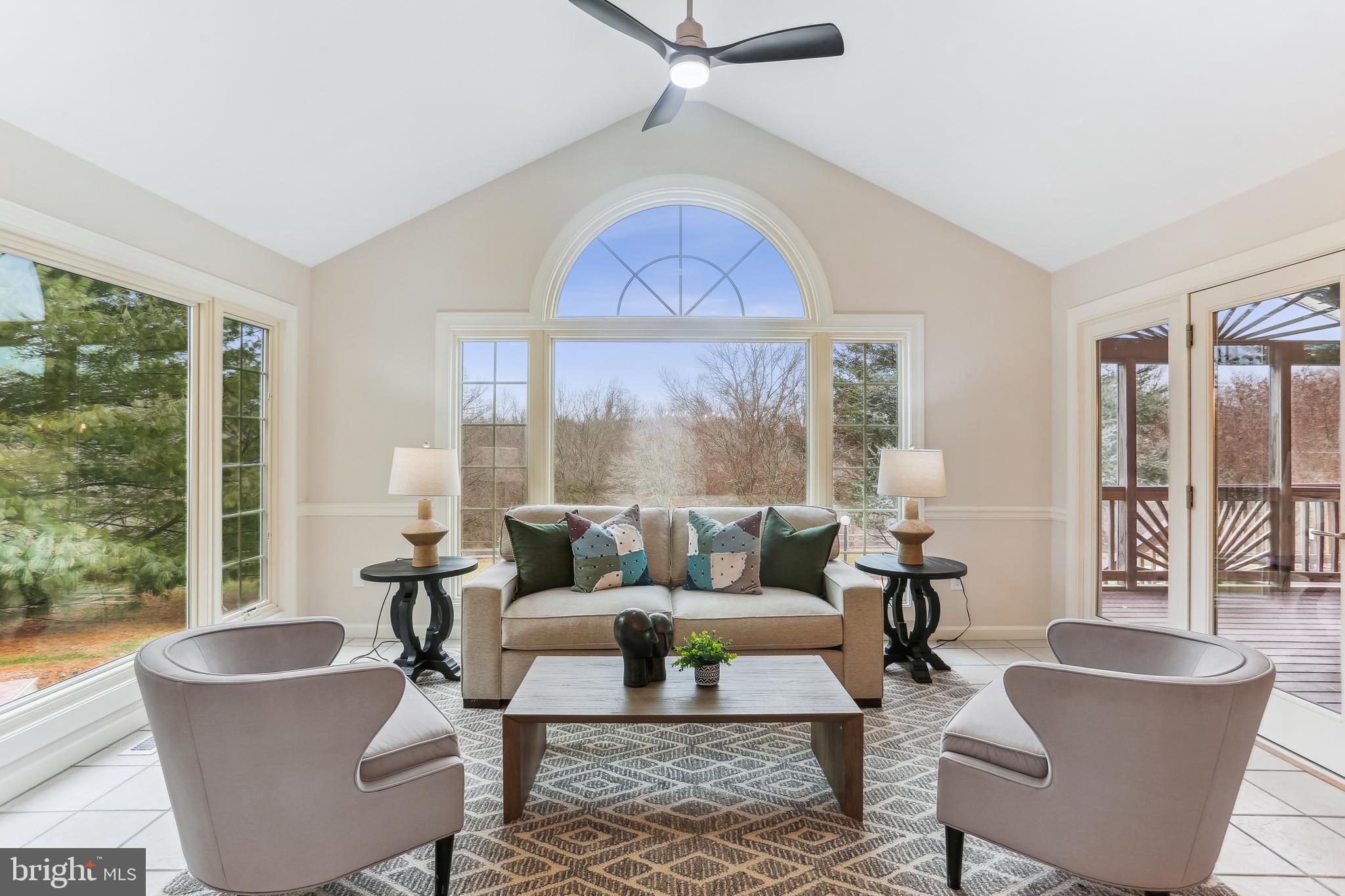 9409 Thornedike Drive Laytonsville, MD 20882 - Photo 22 of 86 a living room with furniture a large window and a table