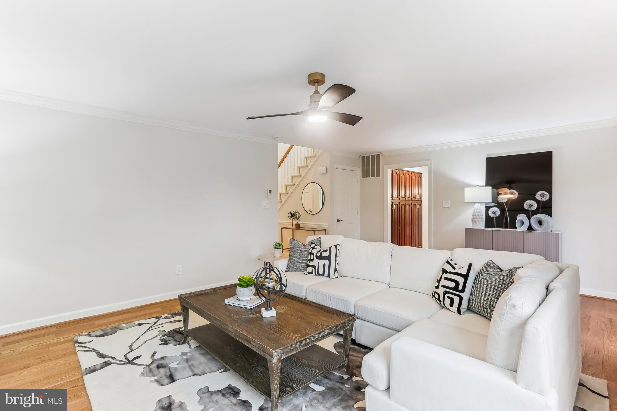 9409 Thornedike Drive Laytonsville, MD 20882 - Photo 25 of 86 a living room with furniture a rug and a wooden floor