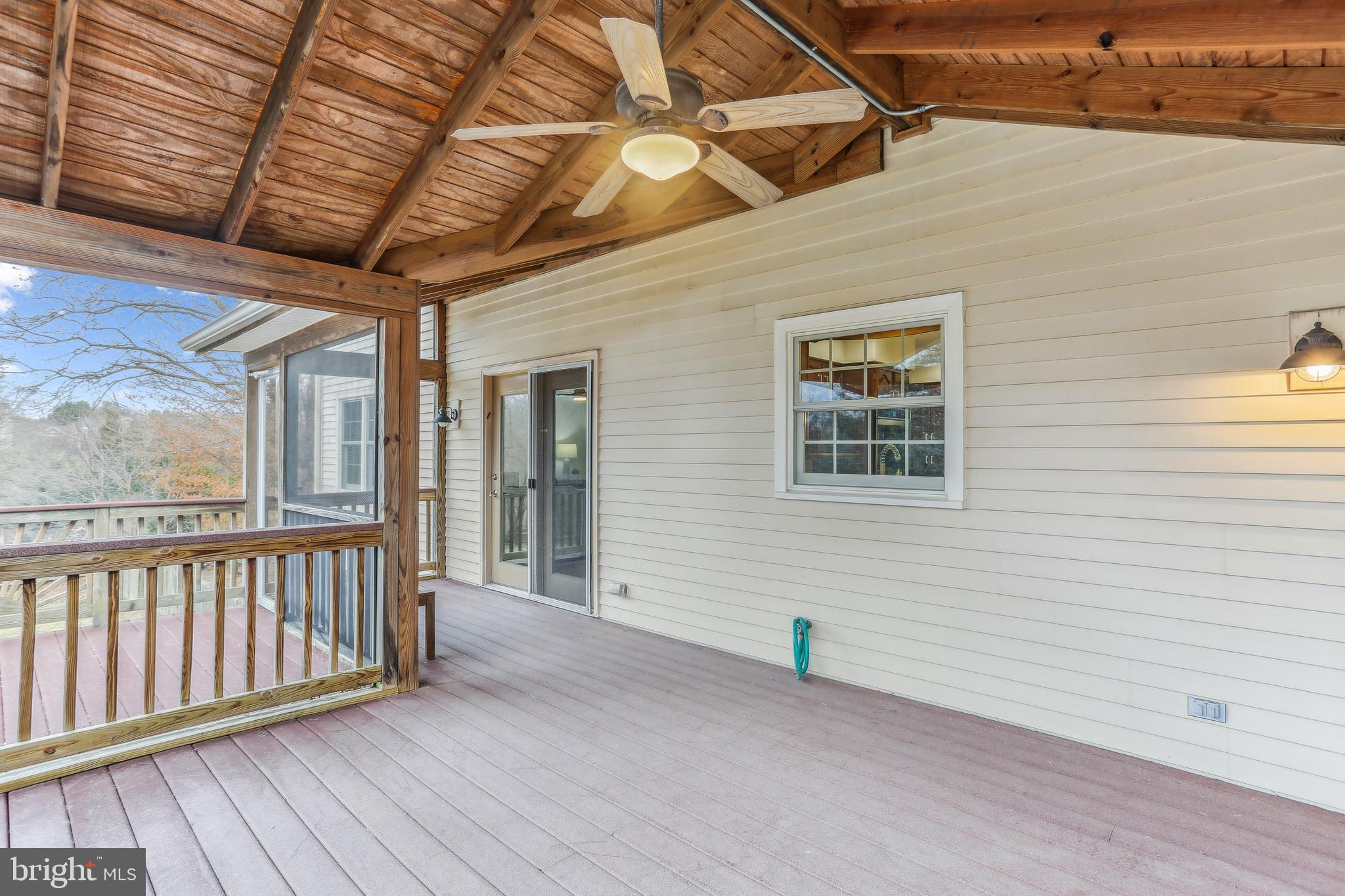9409 Thornedike Drive Laytonsville, MD 20882 - Photo 30 of 86 a view of a house with wooden deck