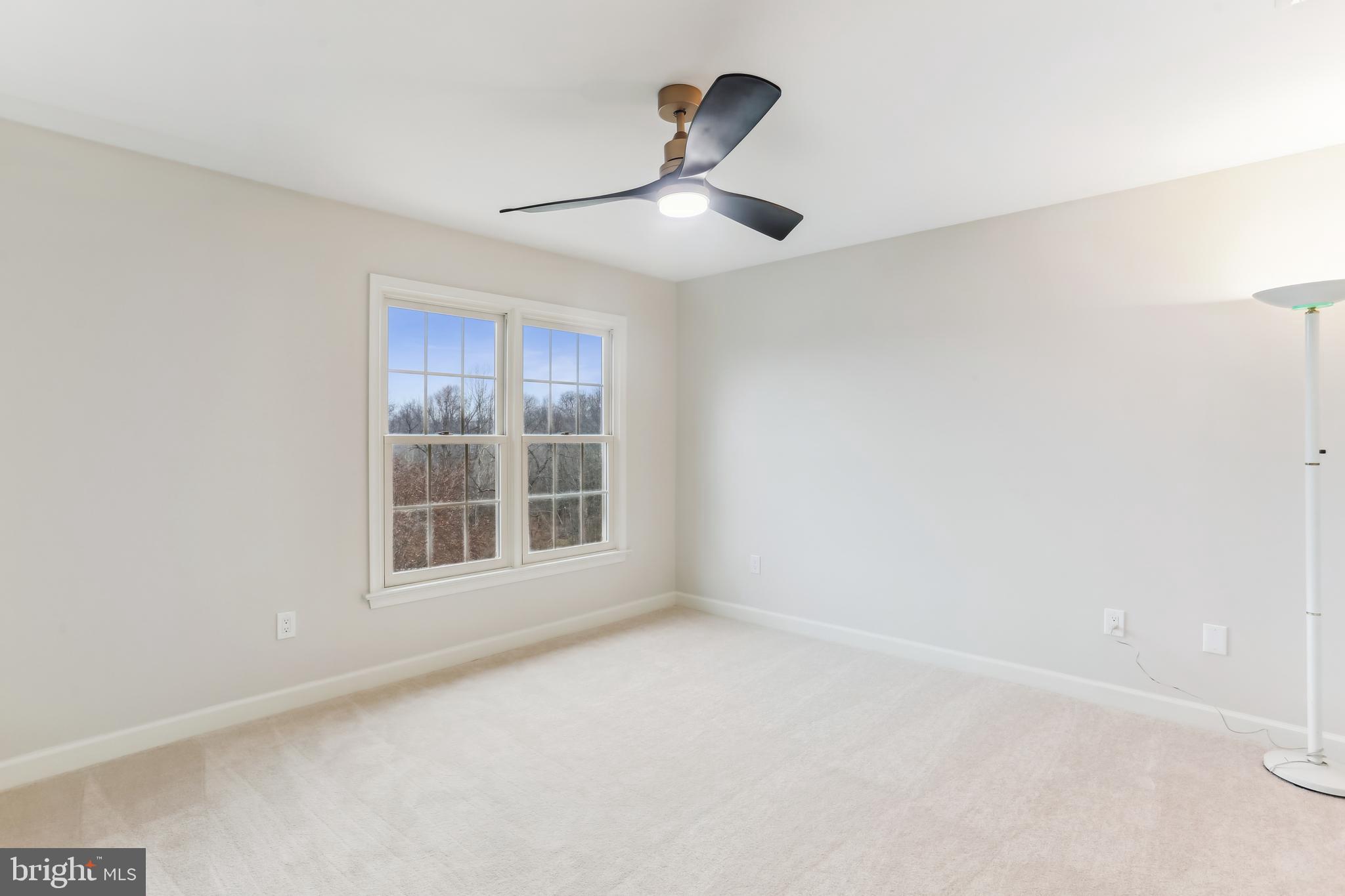 9409 Thornedike Drive Laytonsville, MD 20882 - Photo 48 of 86 an empty room with ceiling fan and window