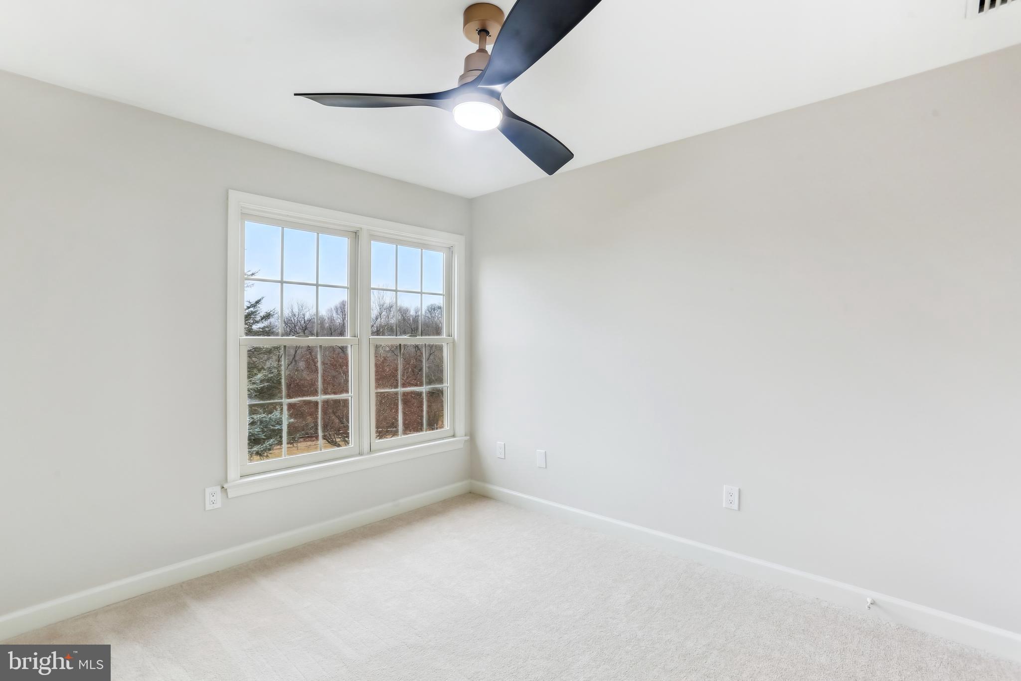 9409 Thornedike Drive Laytonsville, MD 20882 - Photo 51 of 86 an empty room with windows and fan