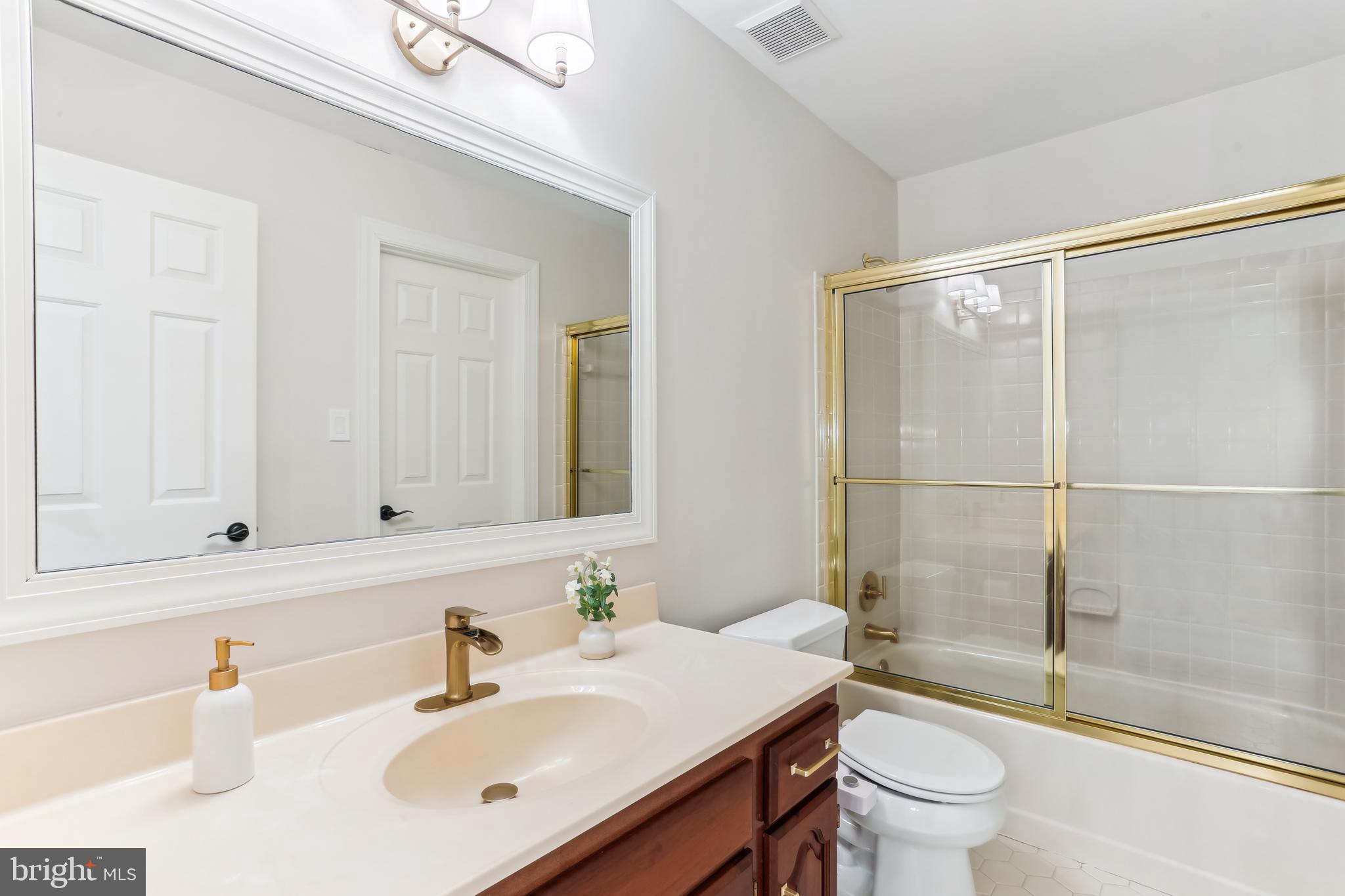 9409 Thornedike Drive Laytonsville, MD 20882 - Photo 55 of 86 a bathroom with a sink toilet and shower