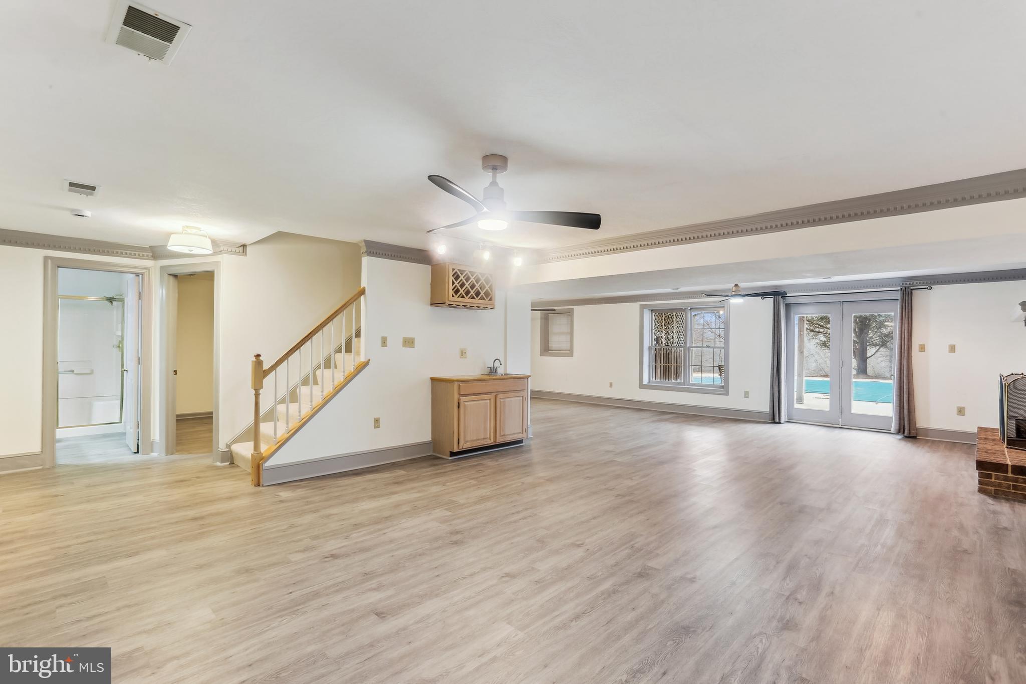 9409 Thornedike Drive Laytonsville, MD 20882 - Photo 67 of 86 a view of an empty room with wooden floor and a ceiling fan