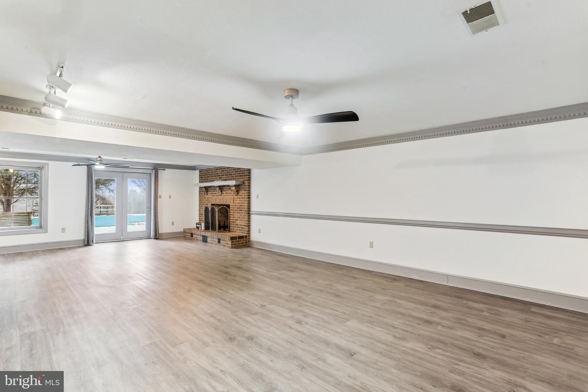 9409 Thornedike Drive Laytonsville, MD 20882 - Photo 68 of 86 wooden floor in an empty room with a window