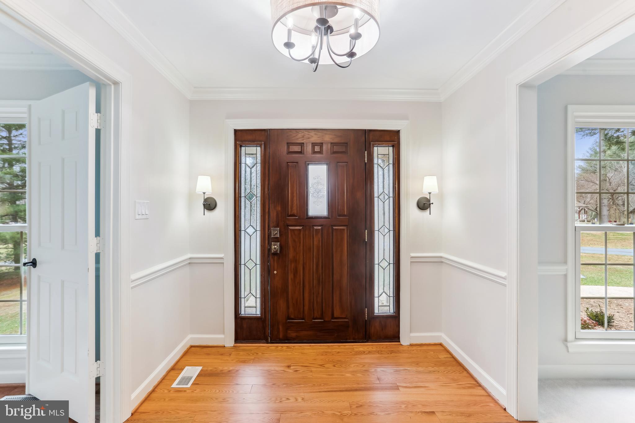 9409 Thornedike Drive Laytonsville, MD 20882 - Photo 7 of 86 a view of a hallway with wooden floor and a window