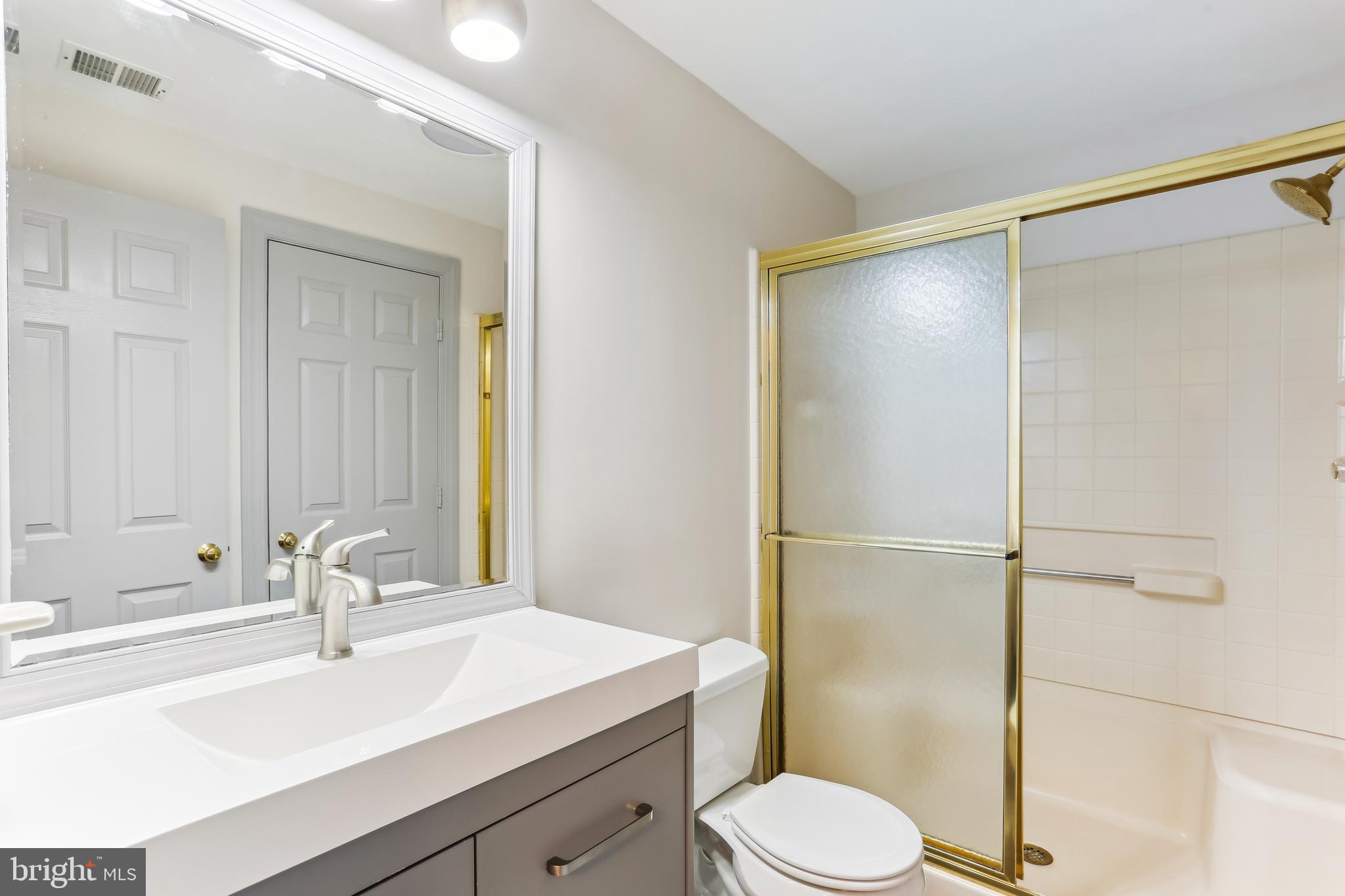9409 Thornedike Drive Laytonsville, MD 20882 - Photo 73 of 86 a bathroom with a sink toilet and shower