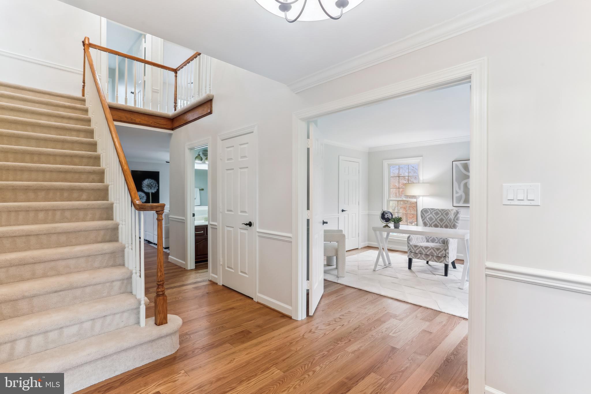 9409 Thornedike Drive Laytonsville, MD 20882 - Photo 8 of 86 a view of a hallway view with wooden floor and staircase