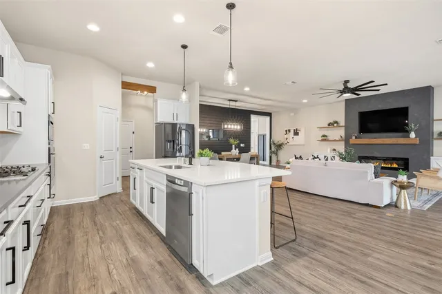 a front view of house with a garden and trees