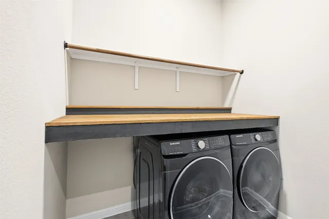 a large white kitchen with wooden floor and a sink