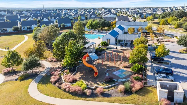 an aerial view of residential houses with outdoor space