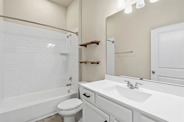a bathroom with a sink a toilet and a large mirror