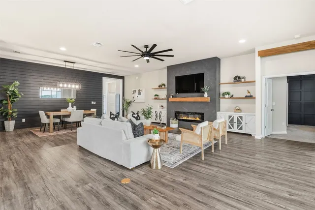 a living room with furniture a fireplace and a flat screen tv