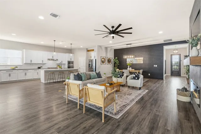 a living room with furniture and kitchen view