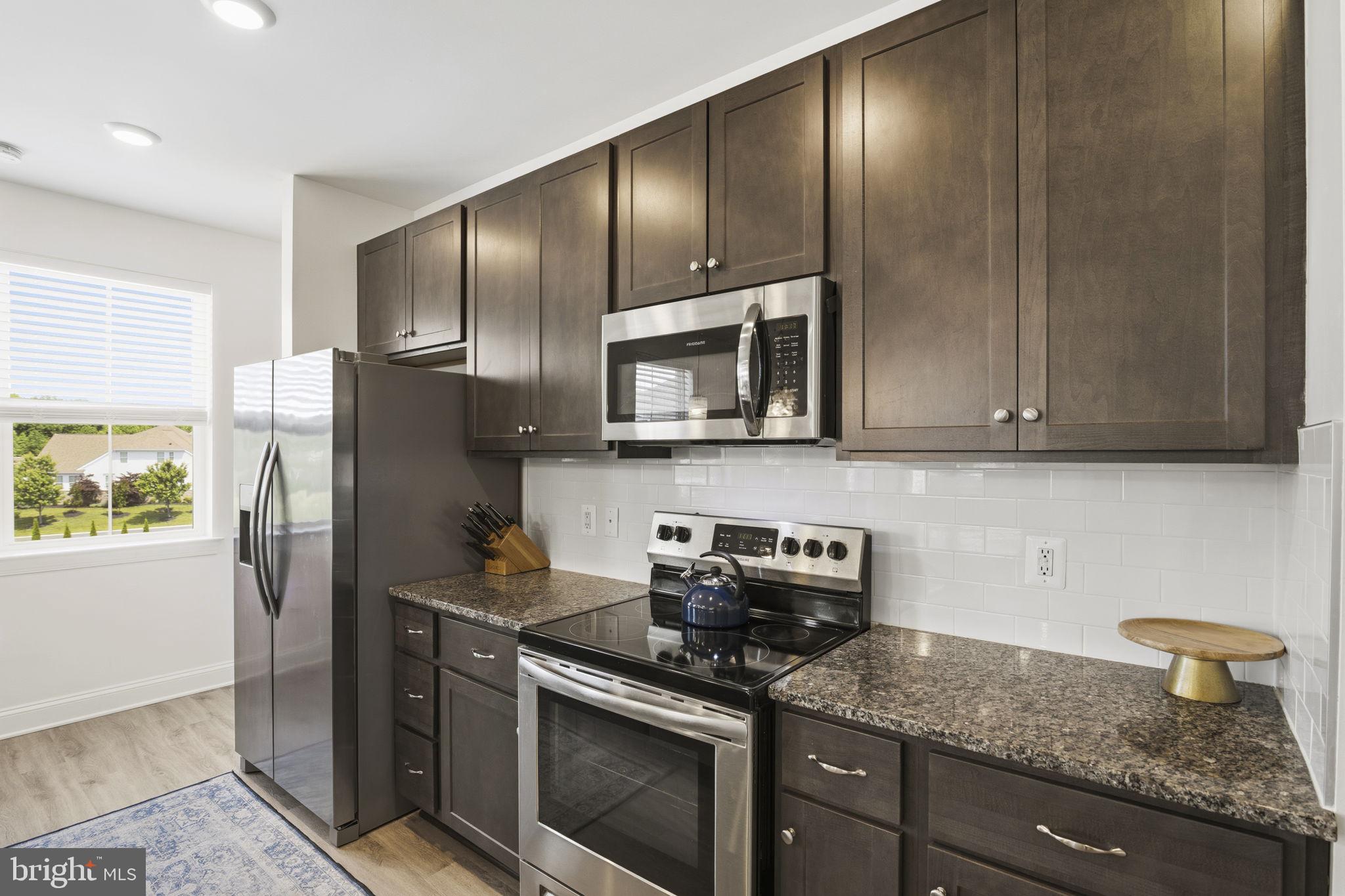 401 Bold Ruler Court, Unit 307 Havre de Grace, MD 21078 - Photo 19 of 32 42" cabinets & tiled backsplash