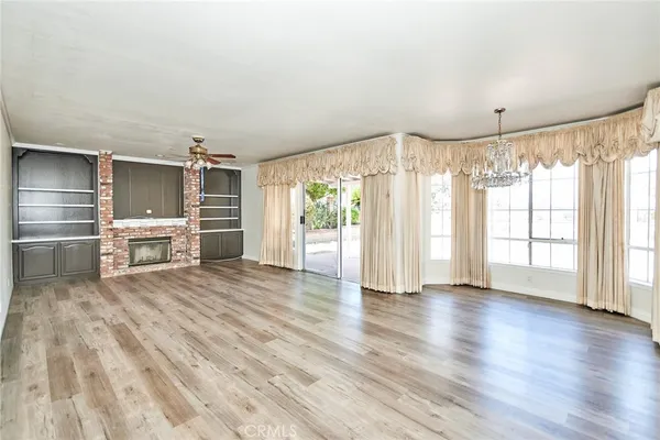 a view of wooden floor and windows in a room