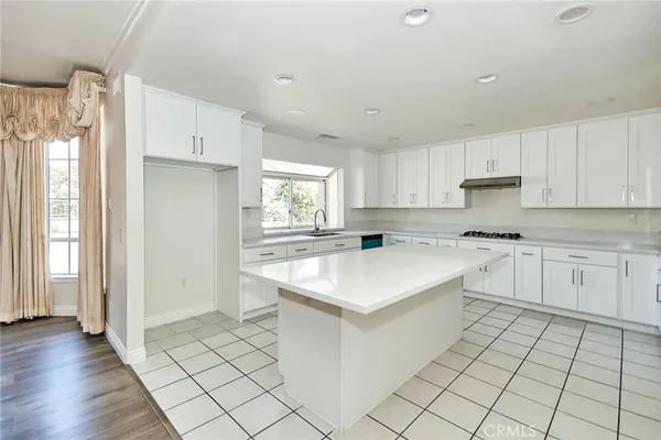 a kitchen with a sink cabinets and window