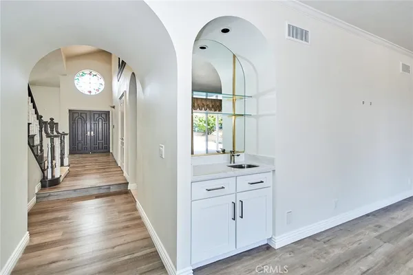 a view of a hallway with wooden floor