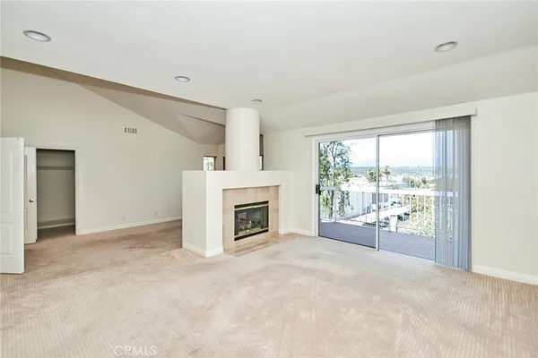 a view of a livingroom with an empty space and a fireplace