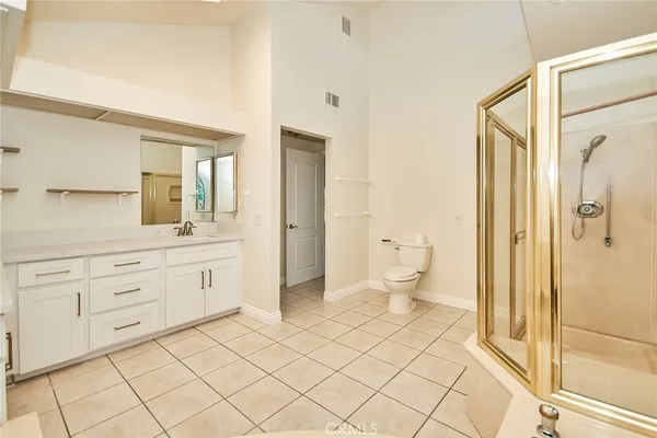 a spacious bathroom with a sink mirror and a toilet