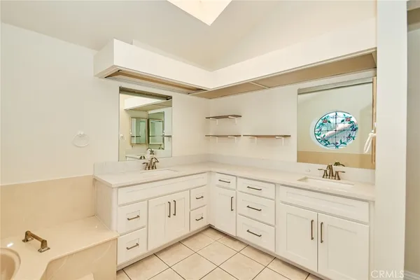 a bathroom with a sink a vanity and a mirror