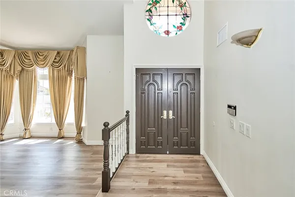 a view of entryway with a window and wooden floor