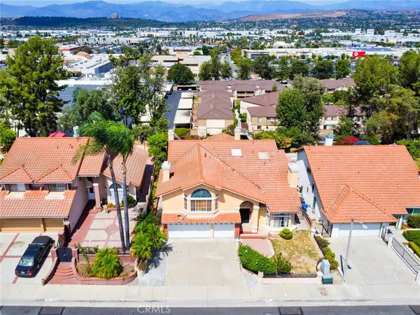 an aerial view of a houses with a swimming pool