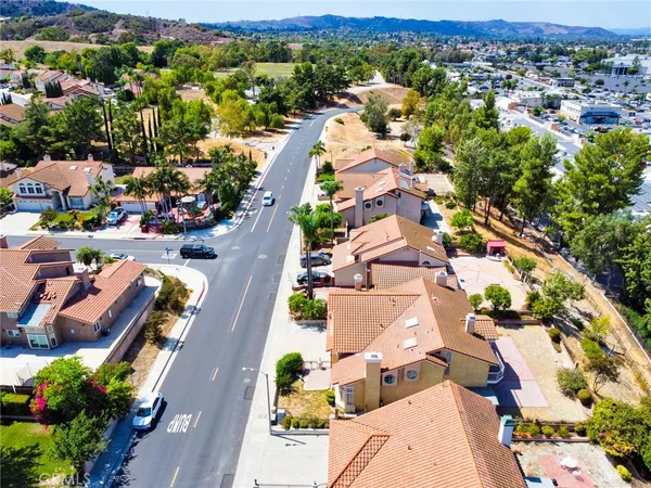 an aerial view of residential houses with outdoor space