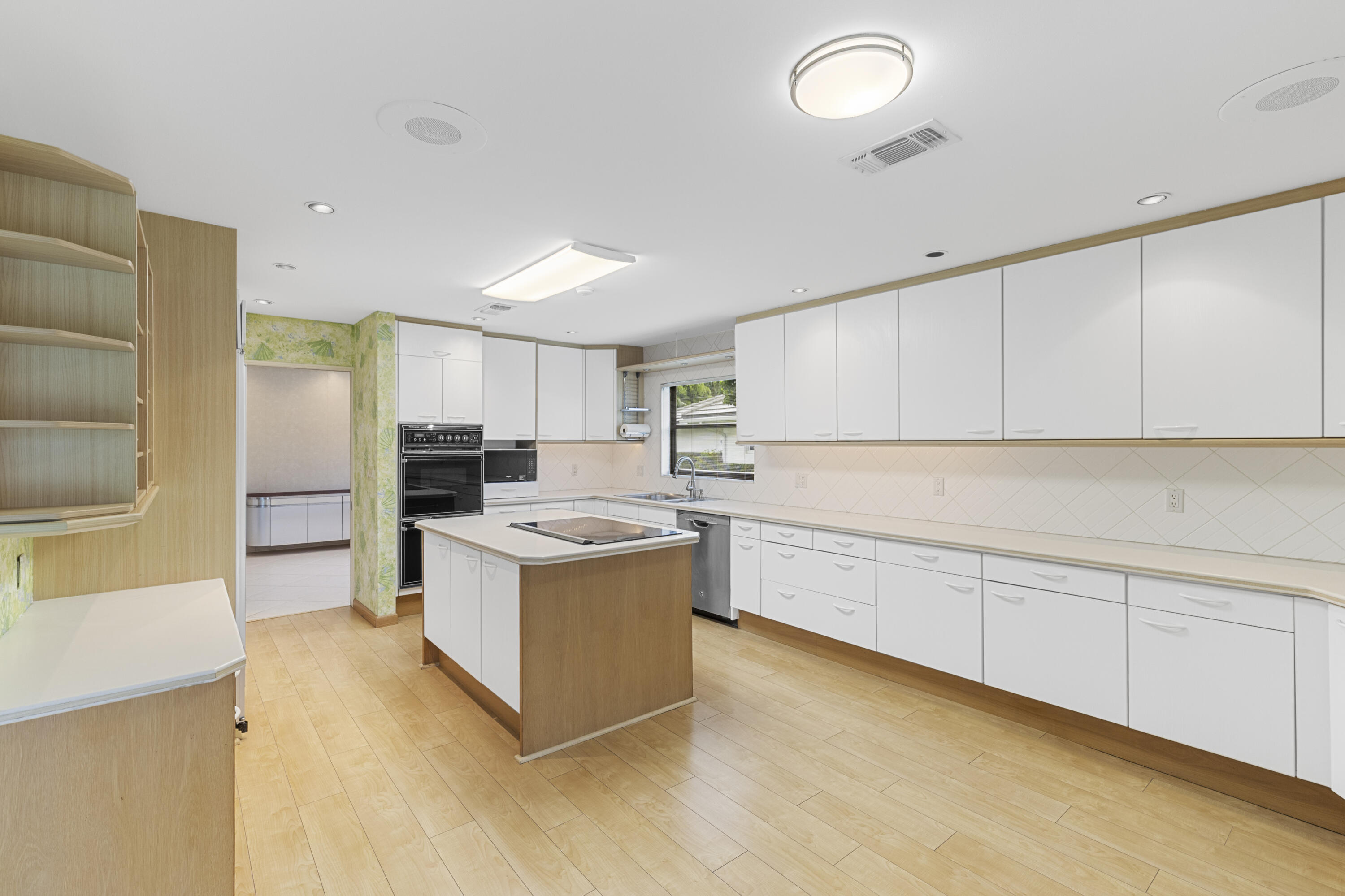 Undisclosed Address Delray Beach, FL 33445 - Photo 11 of 44 a kitchen with granite countertop a sink and a refrigerator