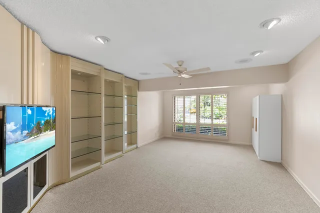 a bedroom with a bed and a large window