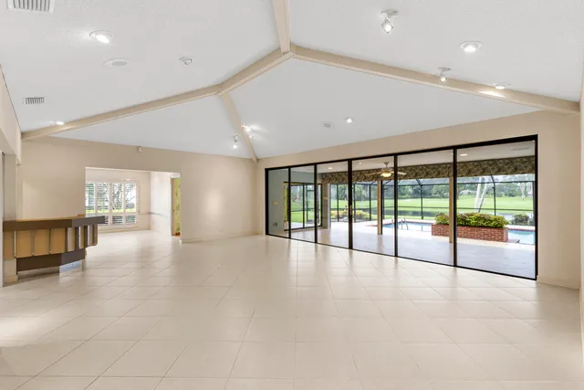 a living room with furniture a rug and a large window