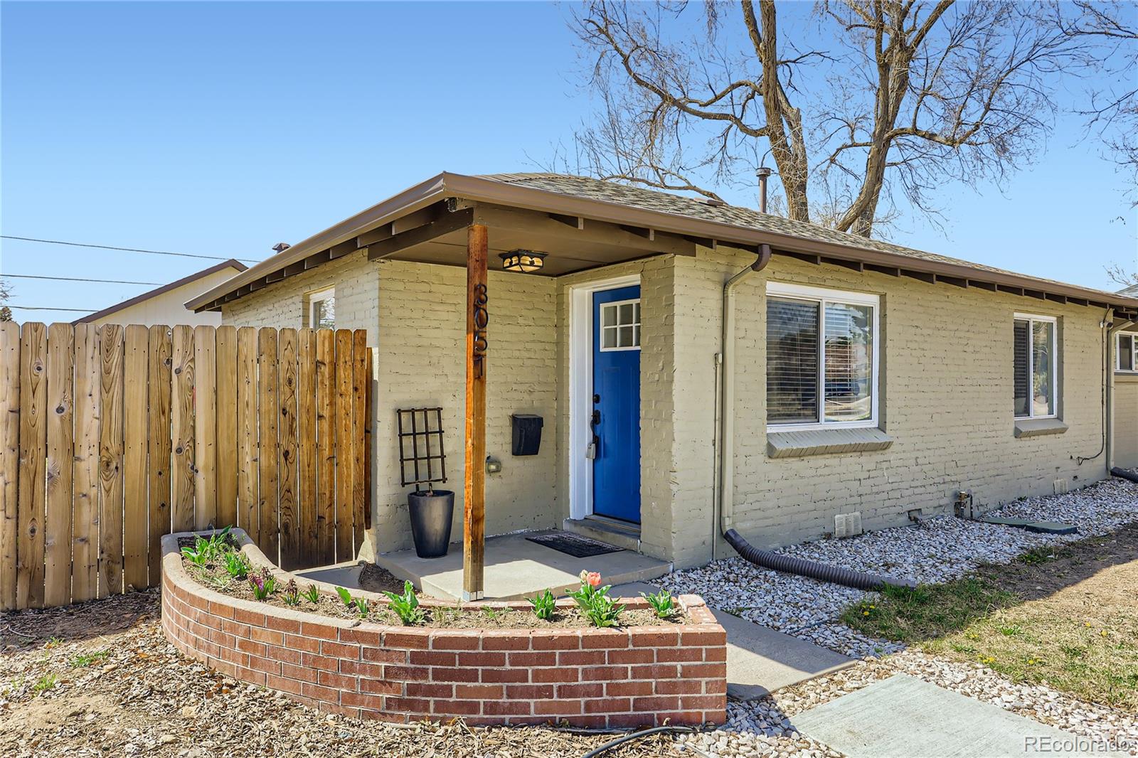 3051 Grape Street Denver, CO 80207 - Photo 1 of 33 a front view of house with a garden