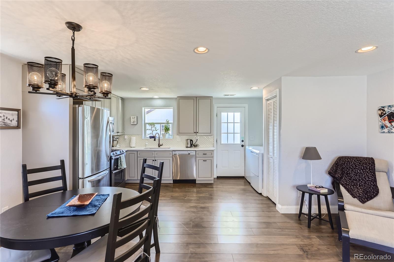 3051 Grape Street Denver, CO 80207 - Photo 11 of 33 a dining room with furniture and wooden floor