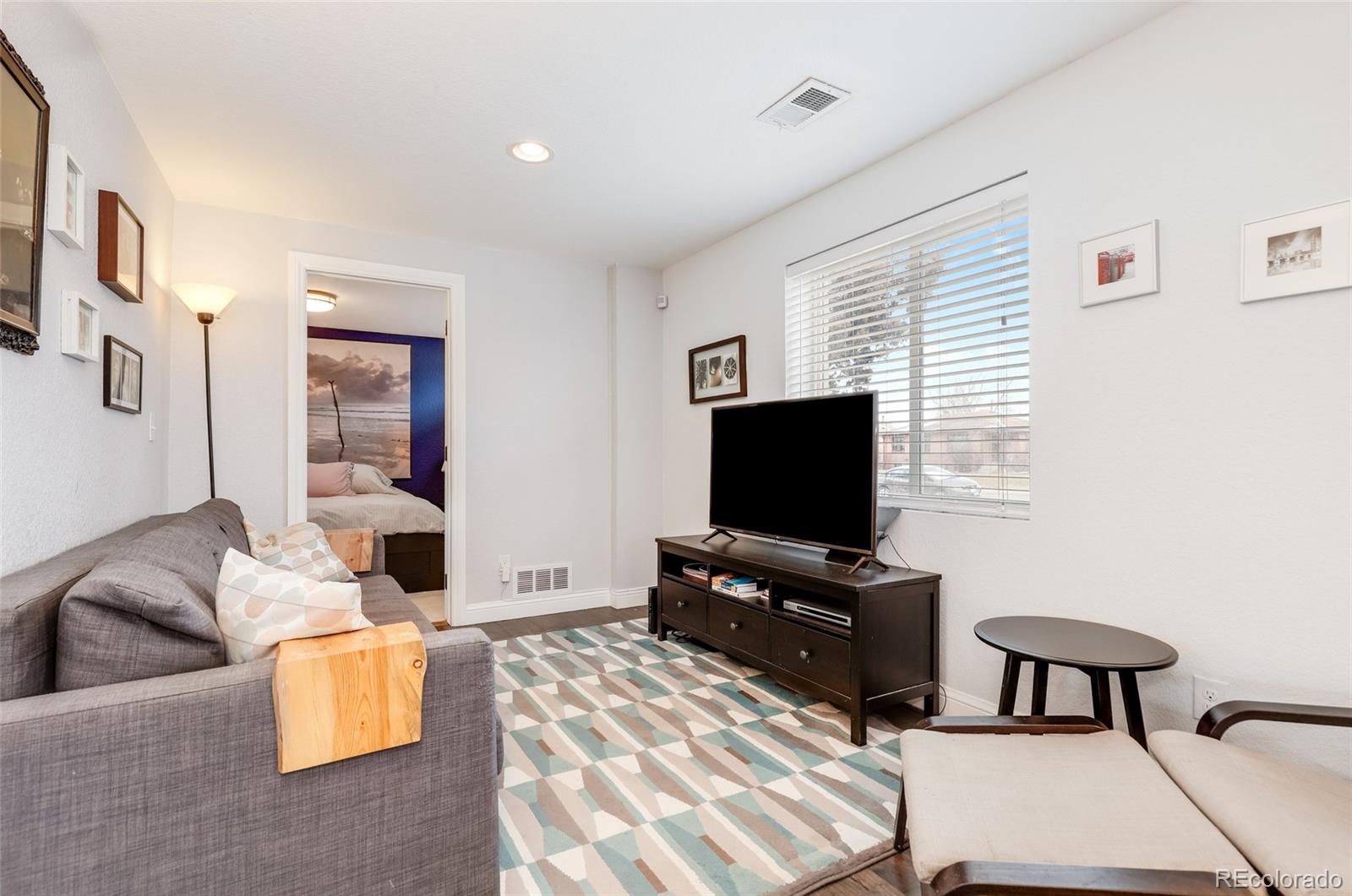 3051 Grape Street Denver, CO 80207 - Photo 17 of 33 a living room with furniture and a flat screen tv