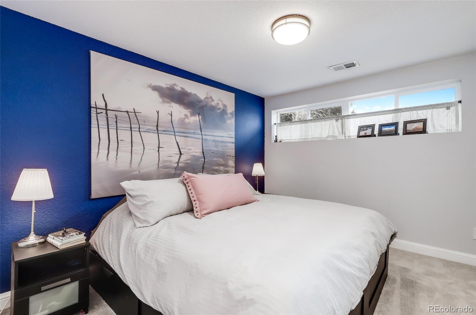 3051 Grape Street Denver, CO 80207 - Photo 20 of 33 a bedroom with a bed and a lamp