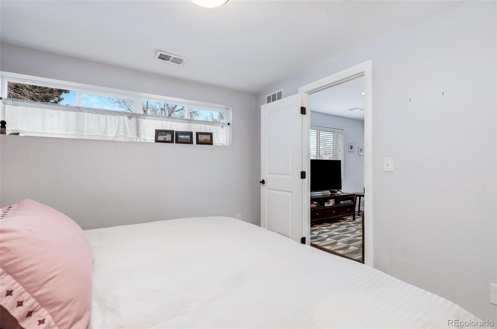 3051 Grape Street Denver, CO 80207 - Photo 21 of 33 a bedroom with a bed and a computer in it