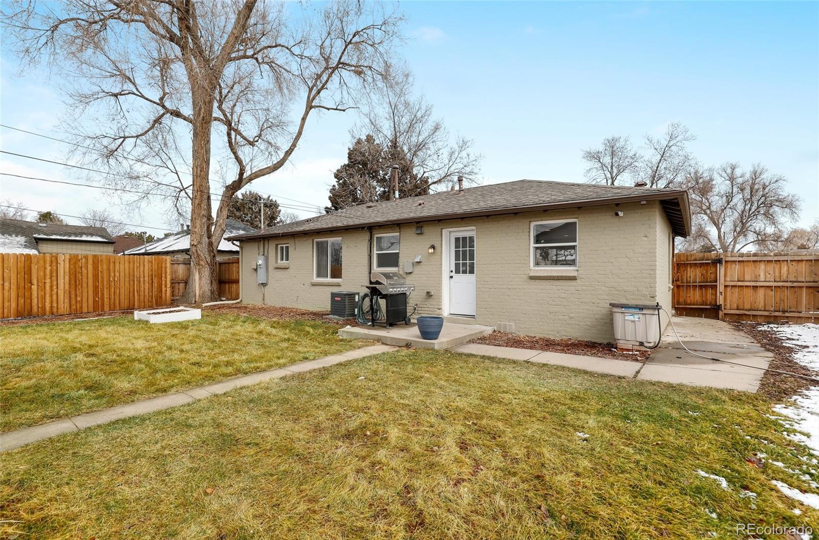 3051 Grape Street Denver, CO 80207 - Photo 27 of 33 a house with trees in the background
