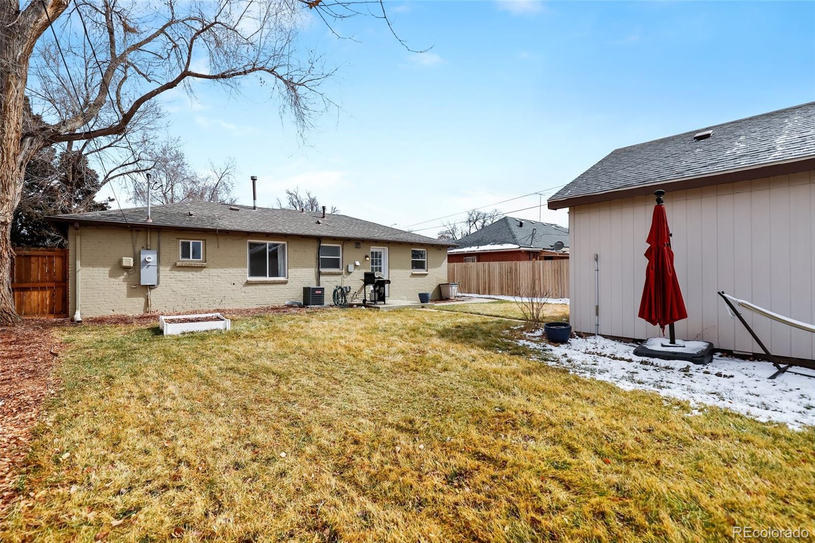 3051 Grape Street Denver, CO 80207 - Photo 29 of 33 a view of a house with a yard and garage
