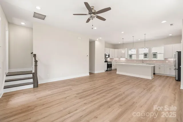 a view of kitchen with wooden floor and window