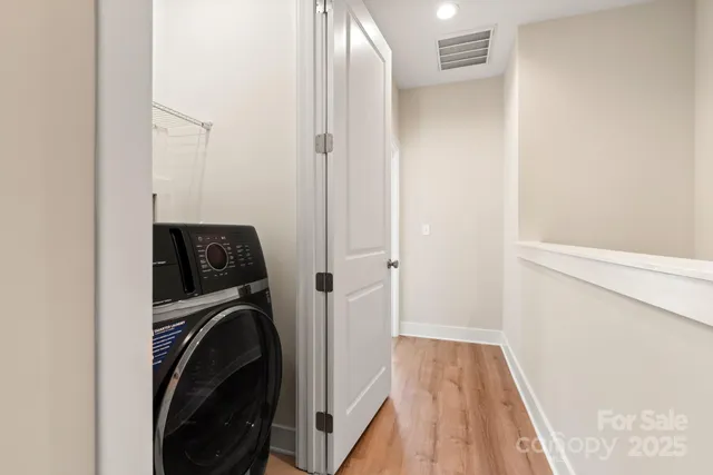 a view of a hallway with washer and dryer