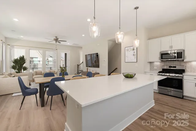 a large kitchen with a table and chairs