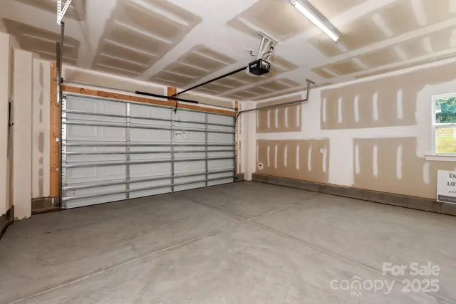 a view of an empty room with projector and a window