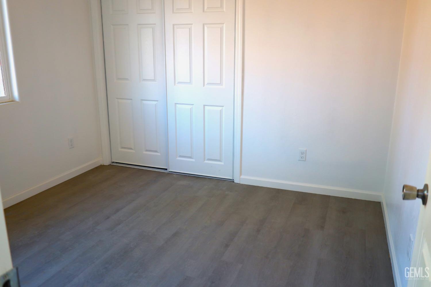 Undisclosed Address Bakersfield, CA 93307 - Photo 11 of 12 an empty room with wooden floor