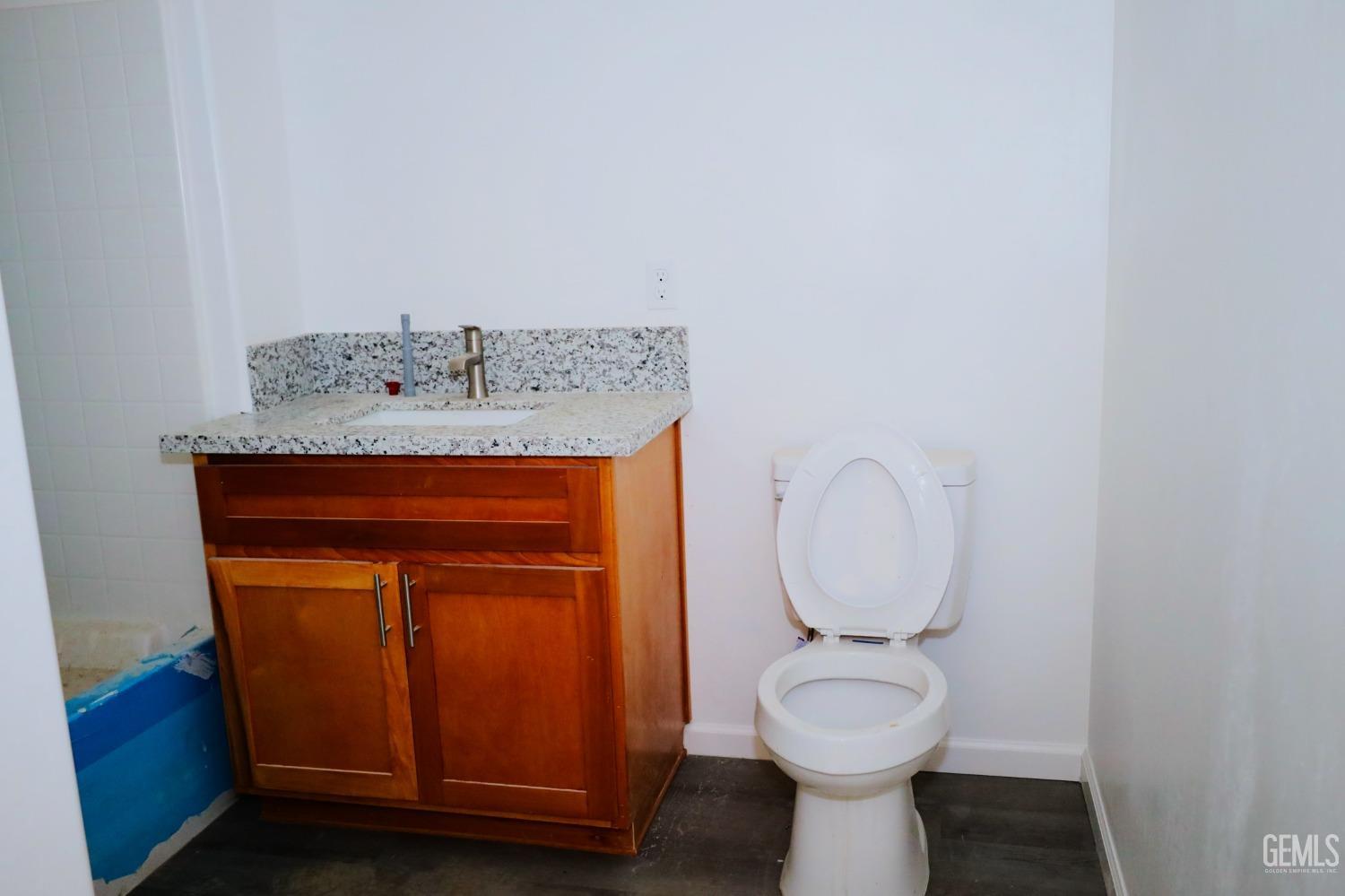 Undisclosed Address Bakersfield, CA 93307 - Photo 7 of 12 a bathroom with a toilet and a sink