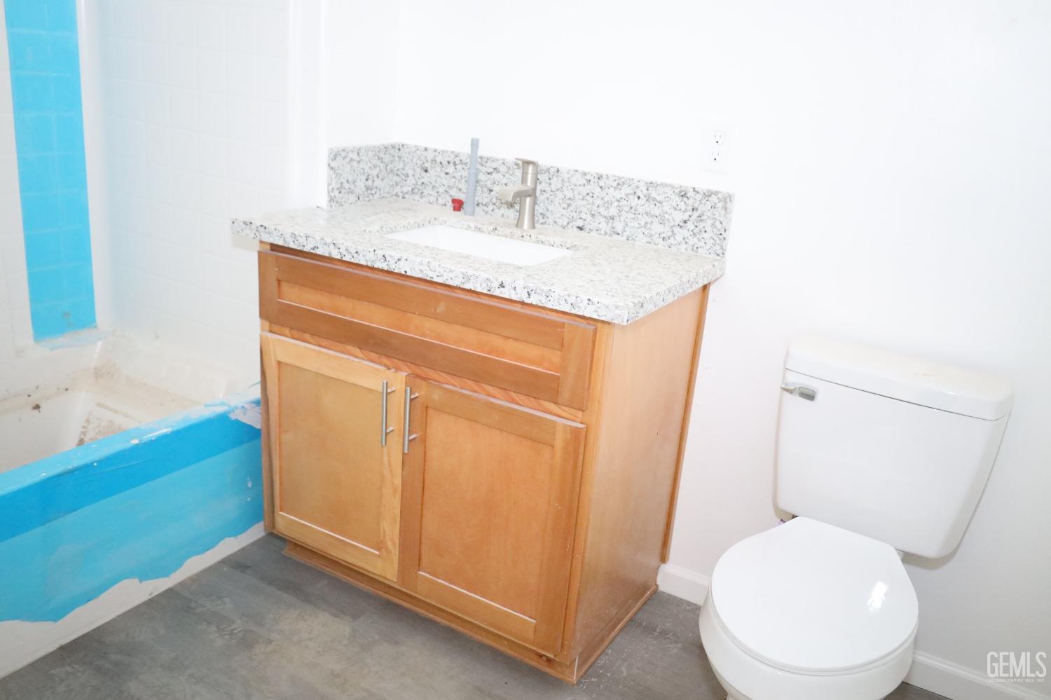 Undisclosed Address Bakersfield, CA 93307 - Photo 8 of 12 a bathroom with a toilet sink and mirror