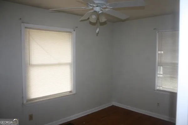a very nice looking hallway with a chandelier fan